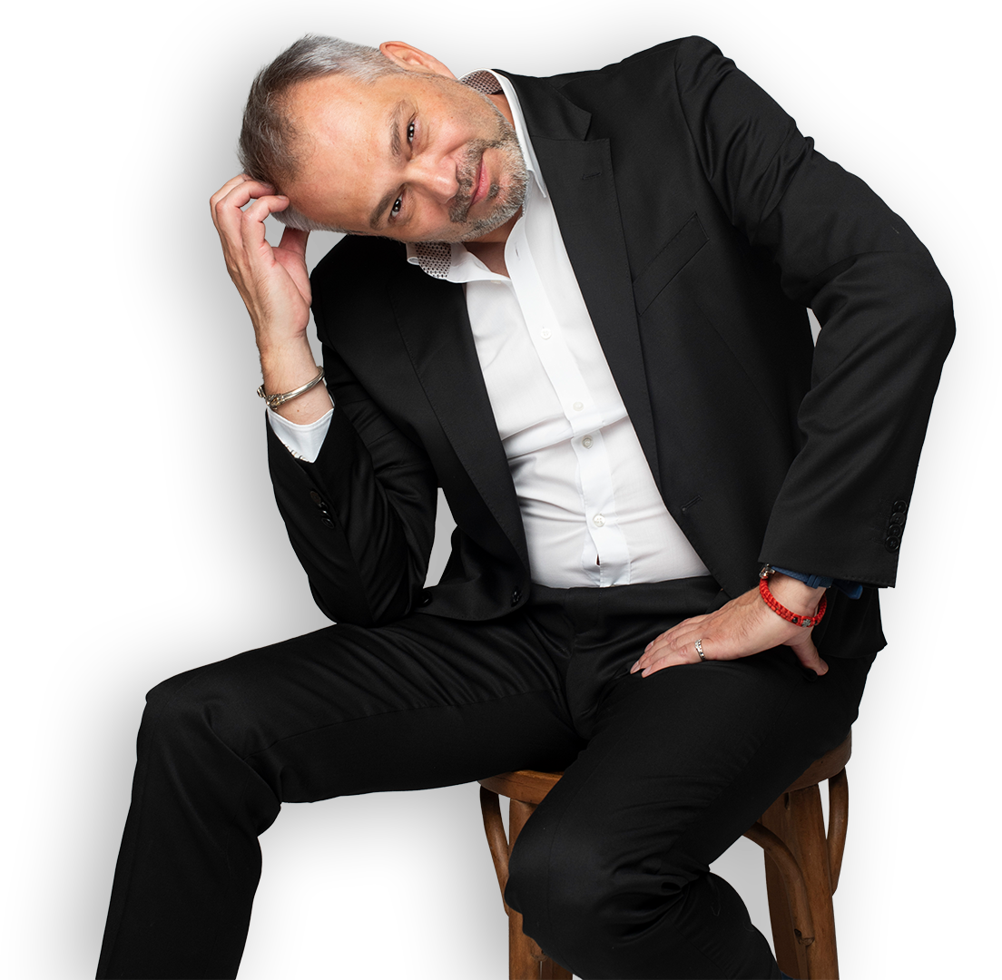 A winemaker holding a glass of red wine, viewed from the back